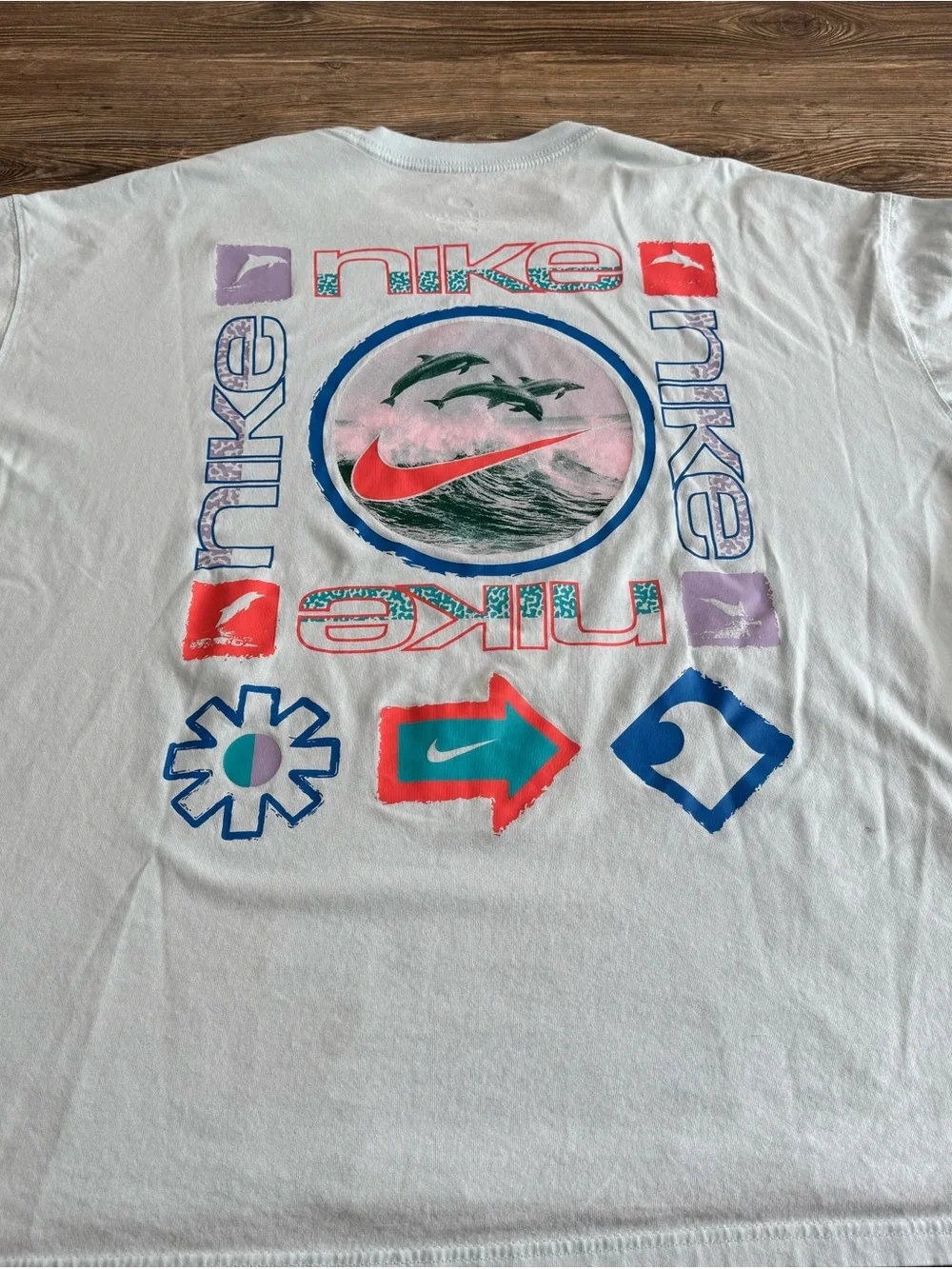 Nike Light Blue Tee with Purple, Red and Teal Icons